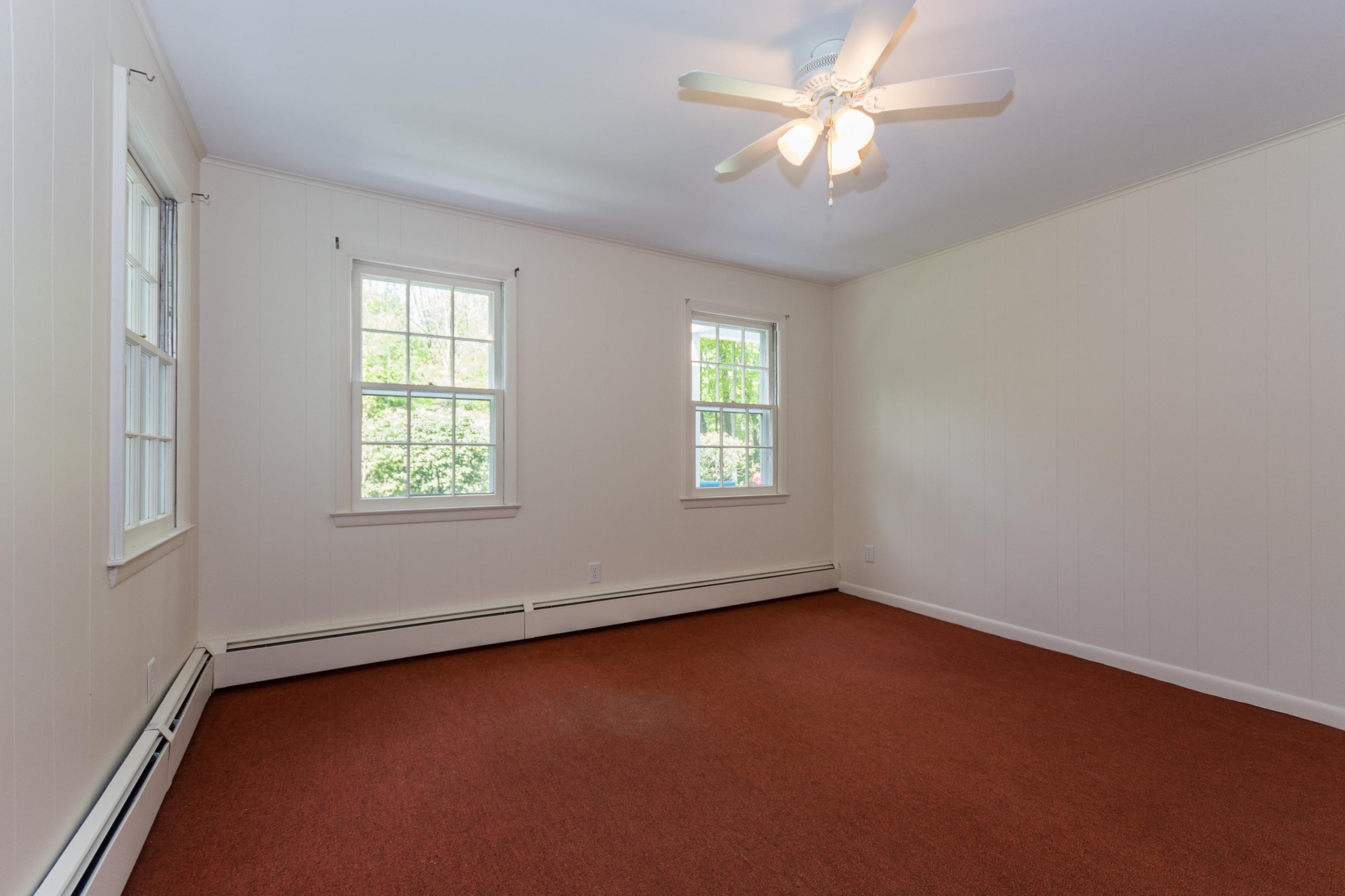 145 Middlesex Road Darien, CT 06820 - Photo 18 of 23 an empty room with windows and fan