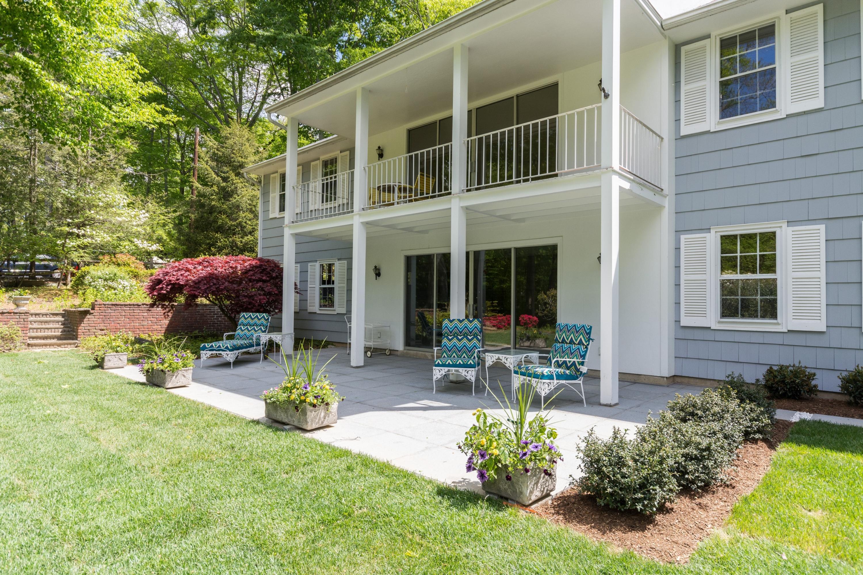 145 Middlesex Road Darien, CT 06820 - Photo 20 of 23 a view of a house with backyard sitting area and garden