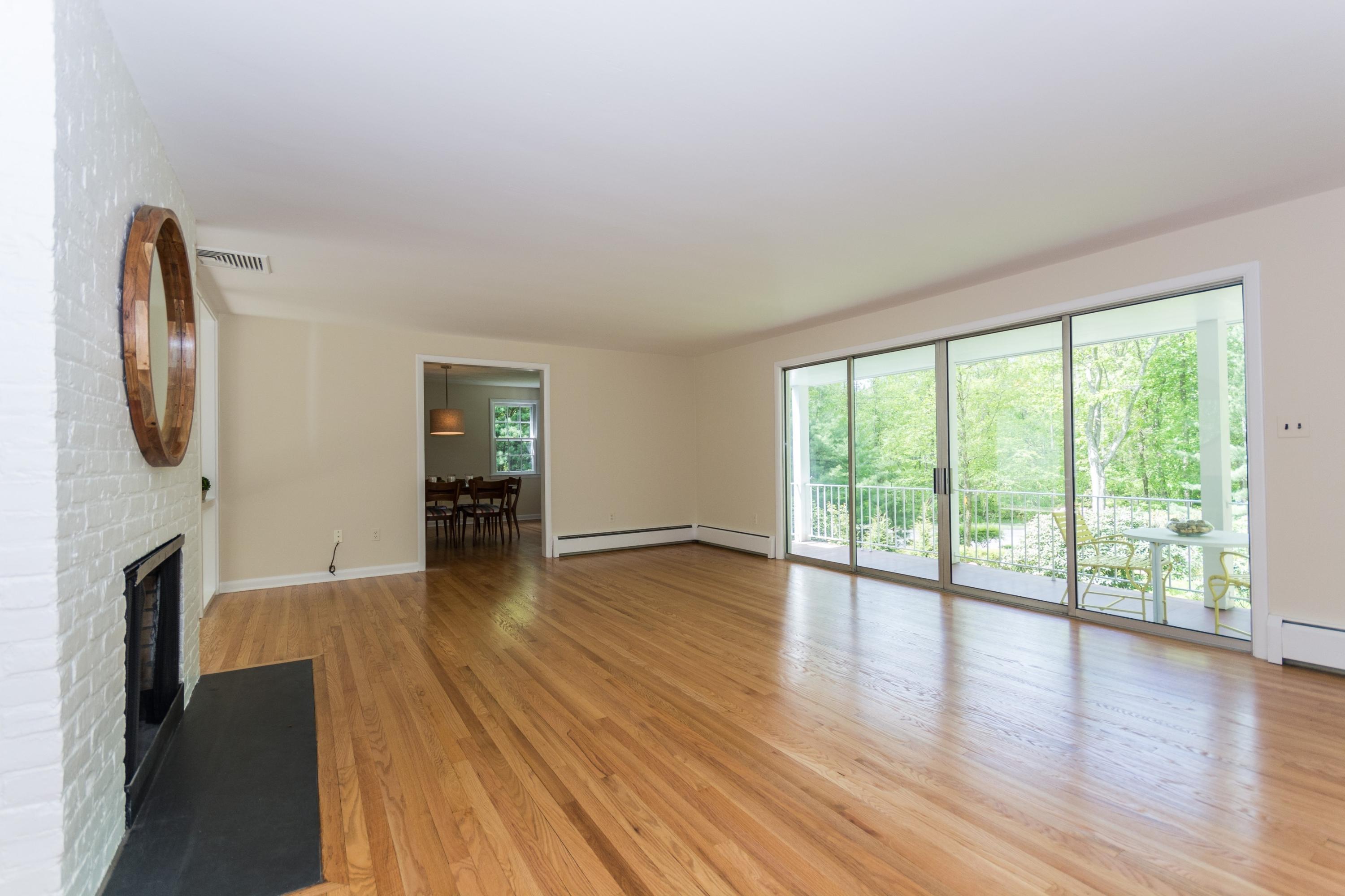 145 Middlesex Road Darien, CT 06820 - Photo 6 of 23 a view of empty room with wooden floor and fan