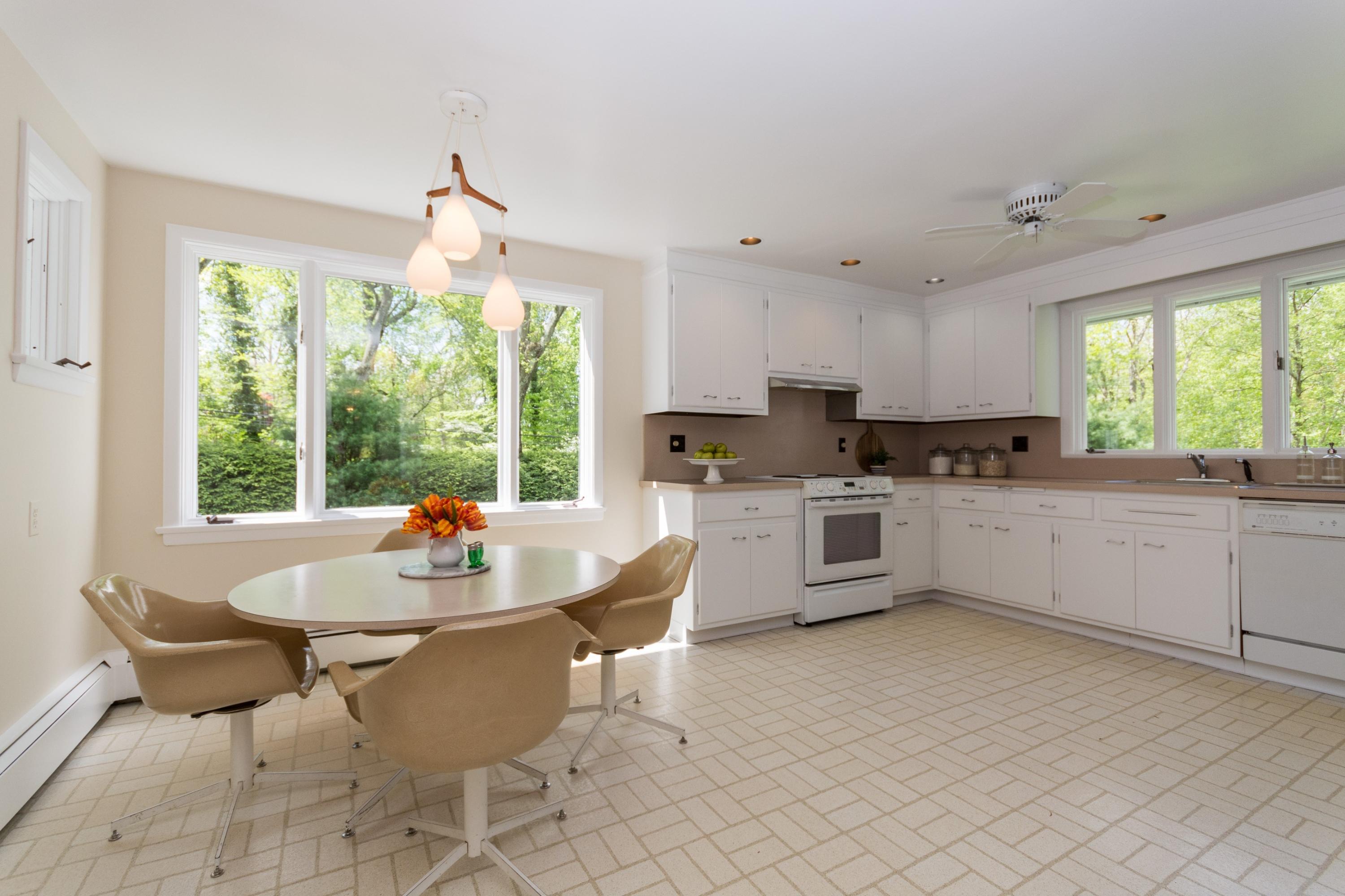 145 Middlesex Road Darien, CT 06820 - Photo 9 of 23 a kitchen with stainless steel appliances kitchen island granite countertop a sink and white cabinets