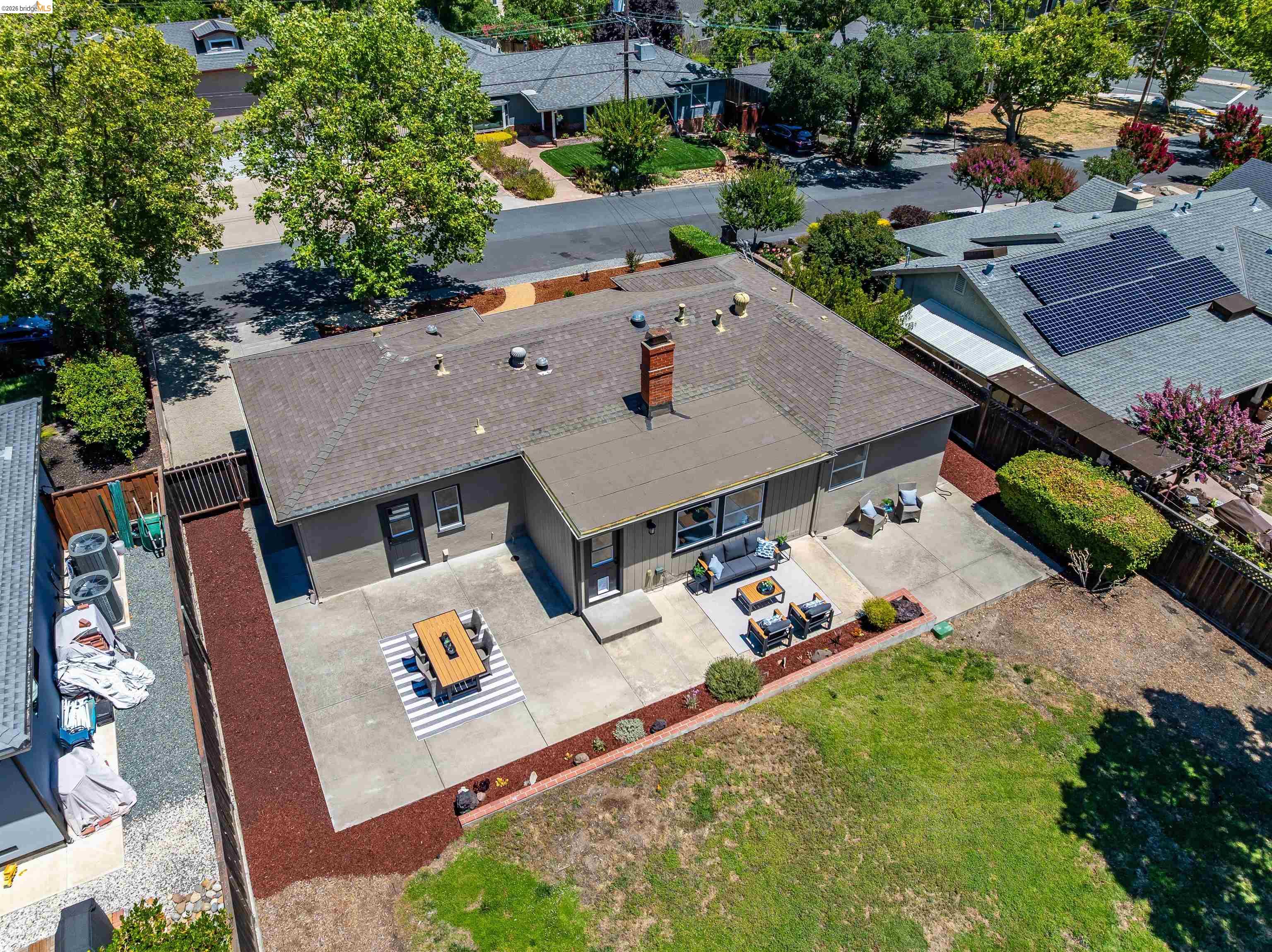 346 Valley View Road Pleasant Hill, CA 94523 - Photo 53 of 57 Expansive backyard featuring a concrete patio, a red bark landscape strip, and an adjacent lawn area