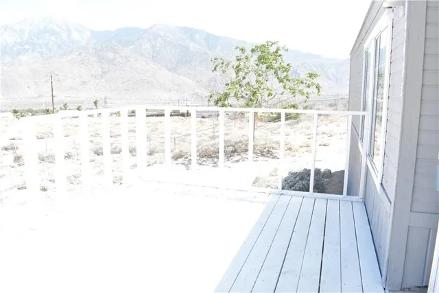 a view of a balcony with wooden floor