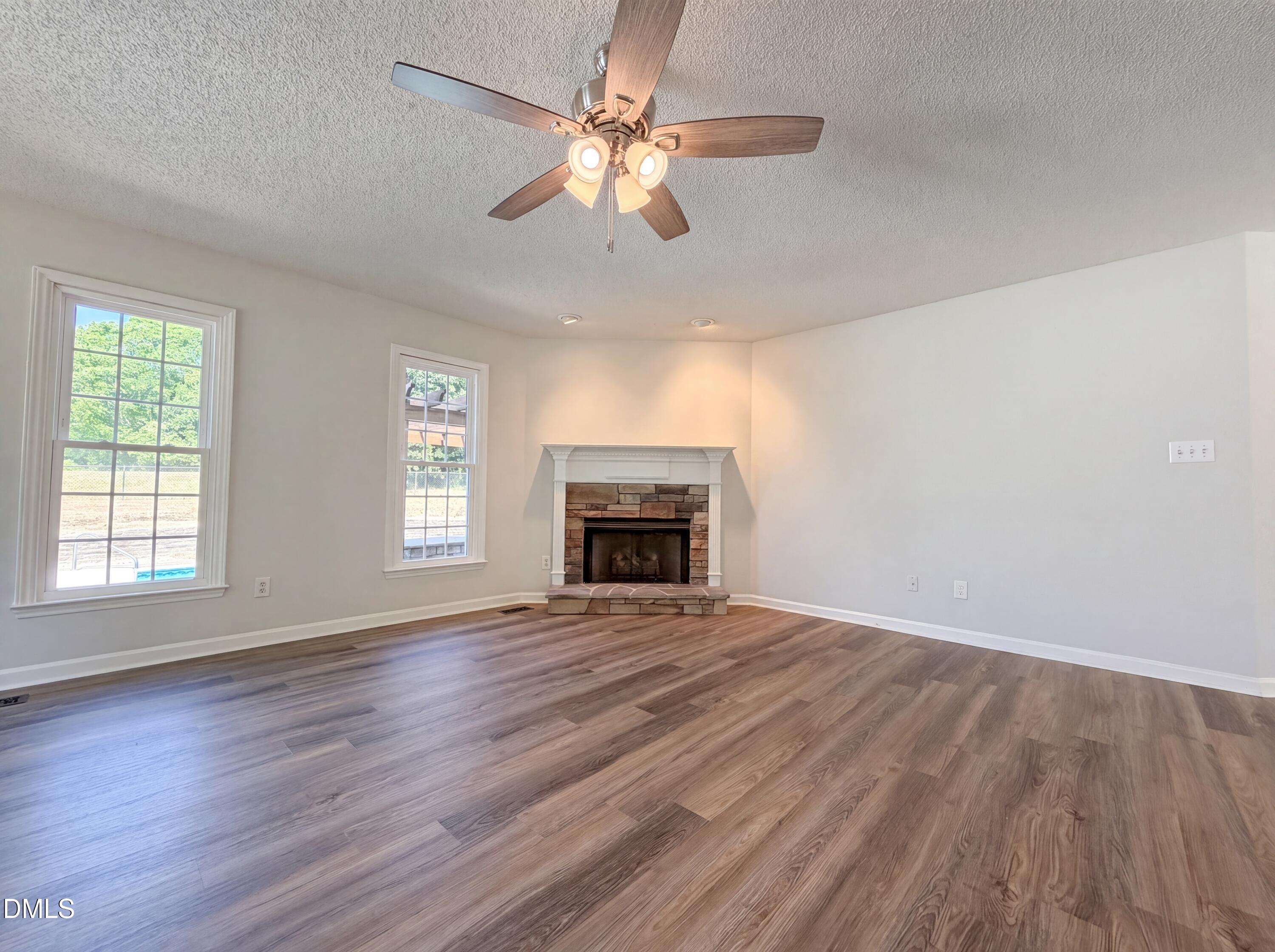 765 Trebor Drive Garner, NC 27529 - Photo 11 of 27 wooden floor fireplace and windows in an empty room