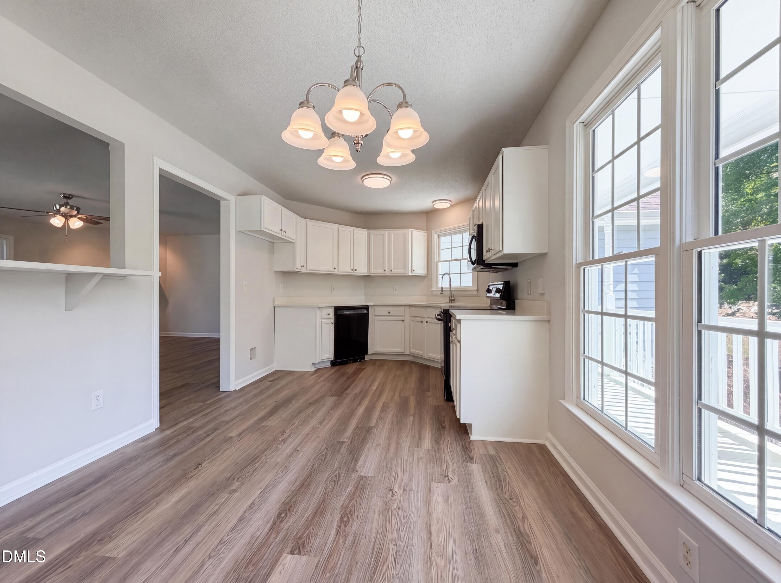 765 Trebor Drive Garner, NC 27529 - Photo 12 of 27 a view of a kitchen with stove and wooden floor
