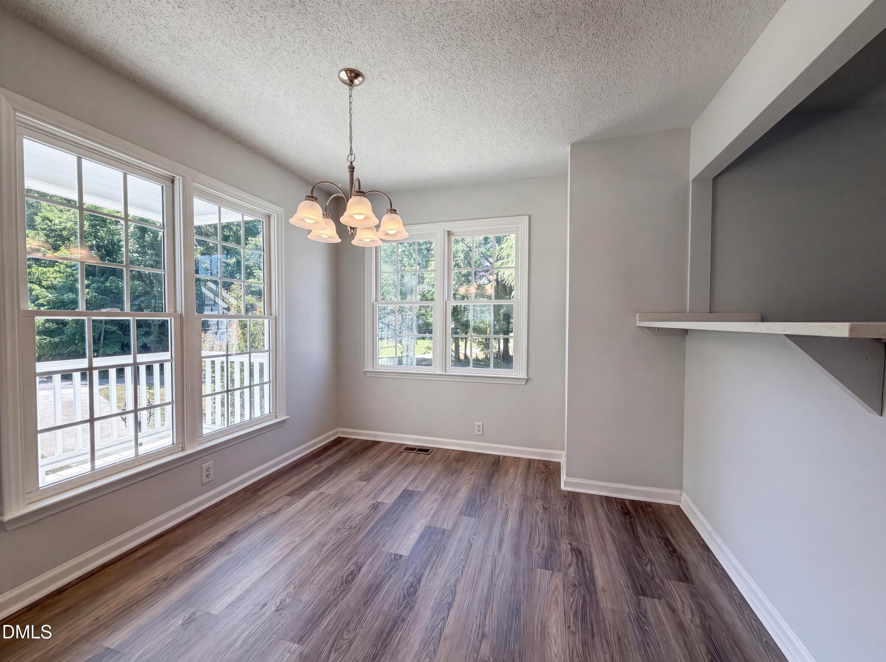 765 Trebor Drive Garner, NC 27529 - Photo 13 of 27 a view of an empty room with wooden floor and a window