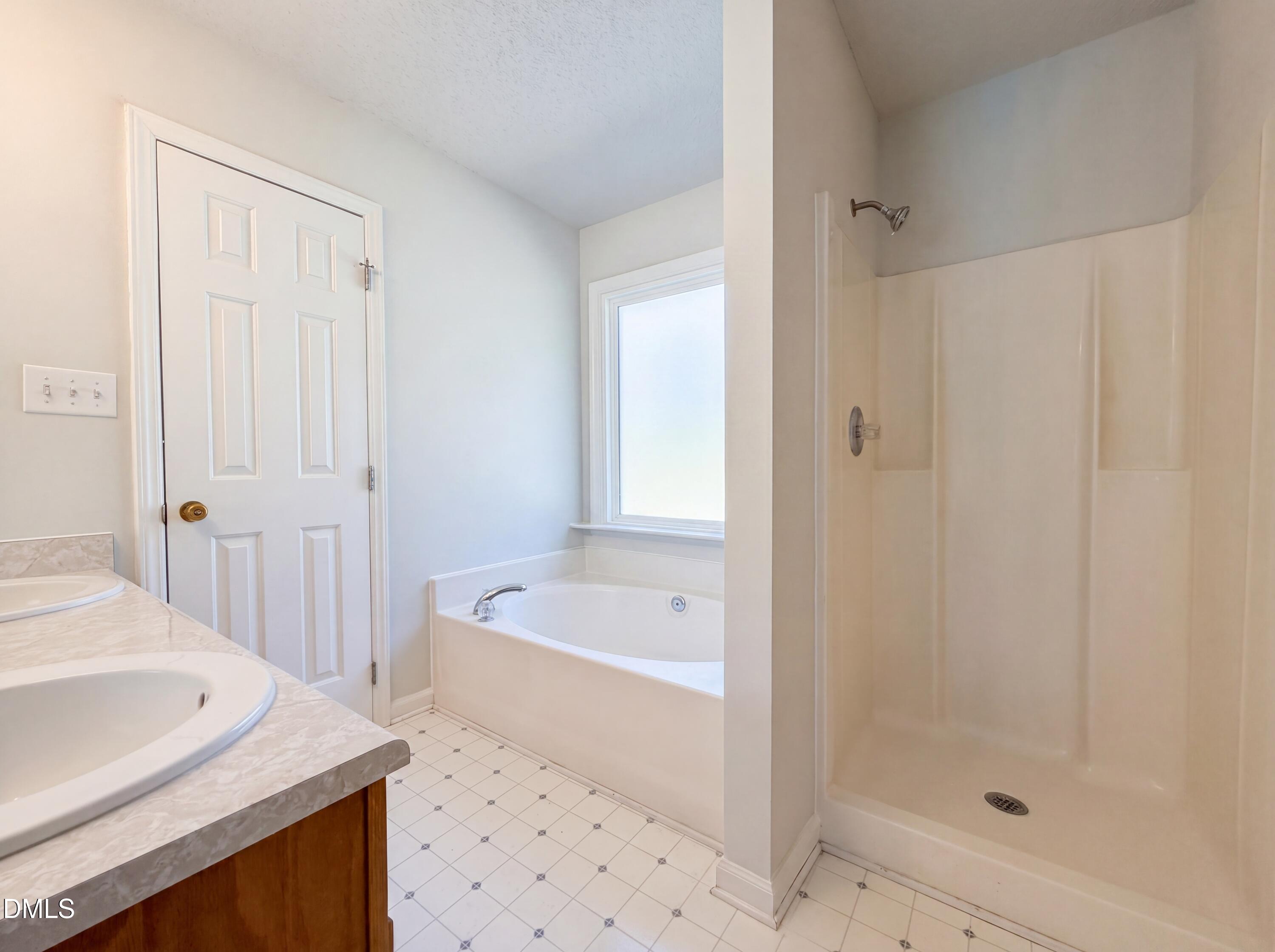 765 Trebor Drive Garner, NC 27529 - Photo 15 of 27 a bathroom with a sink a bathtub and a shower