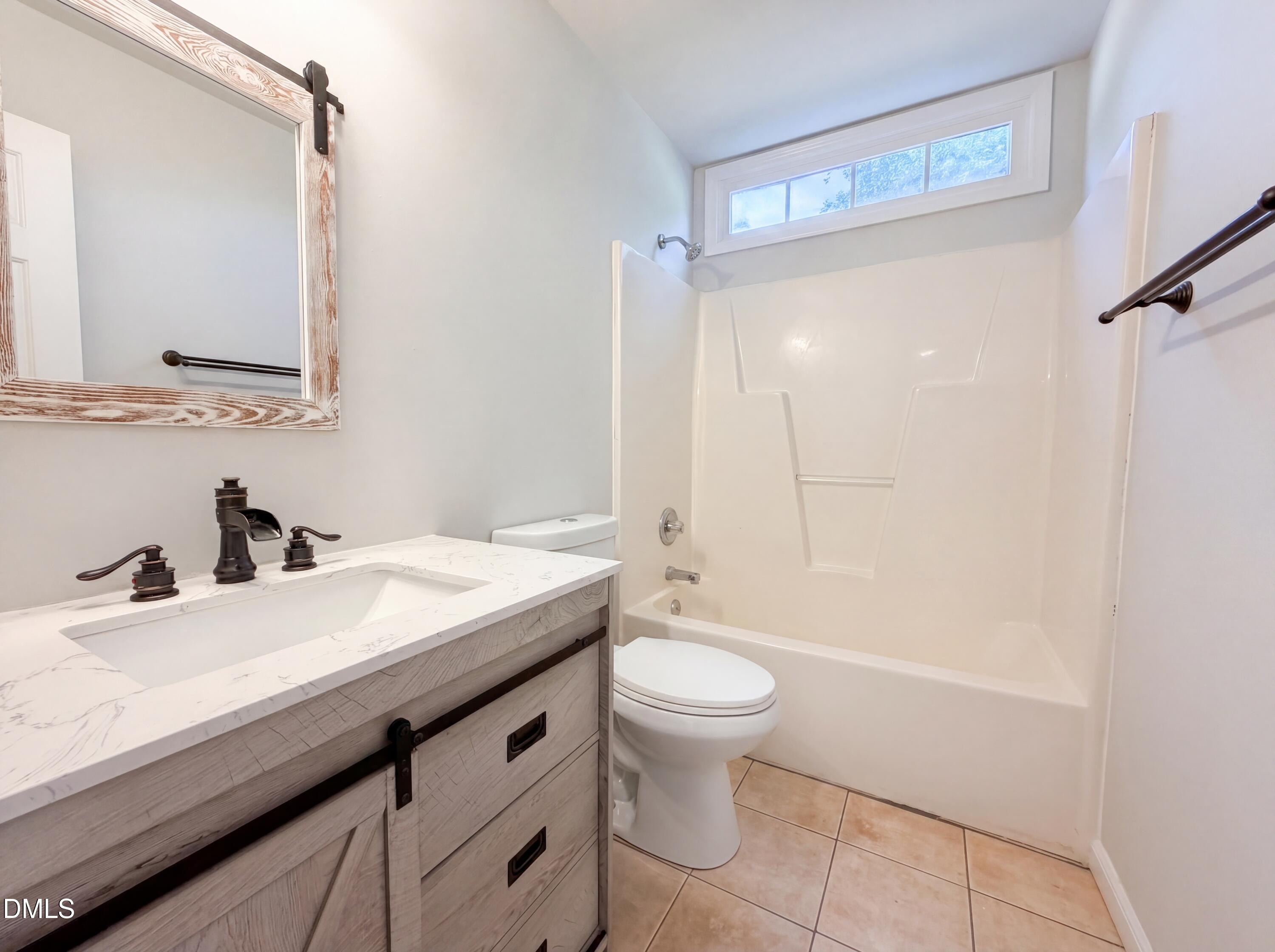 765 Trebor Drive Garner, NC 27529 - Photo 19 of 27 a bathroom with a sink a toilet and shower
