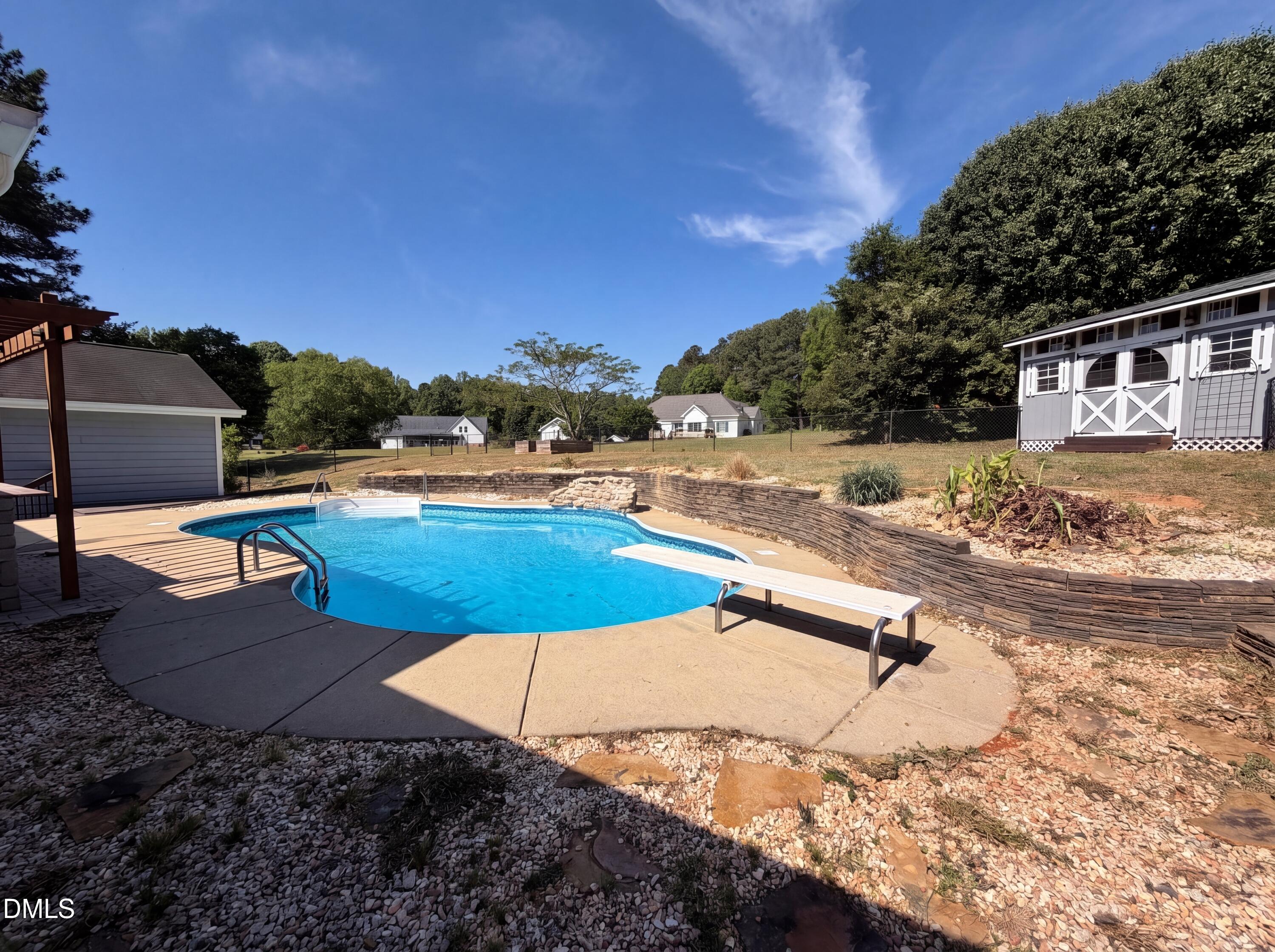 765 Trebor Drive Garner, NC 27529 - Photo 25 of 27 a view of a swimming pool with an outdoor space and seating area