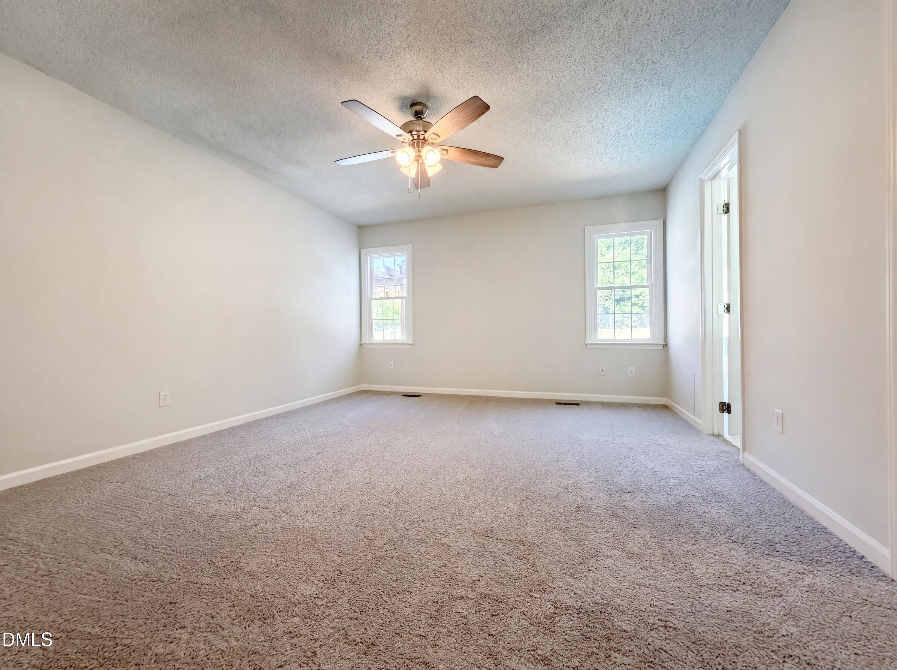 765 Trebor Drive Garner, NC 27529 - Photo 4 of 27 an empty room with windows and fan