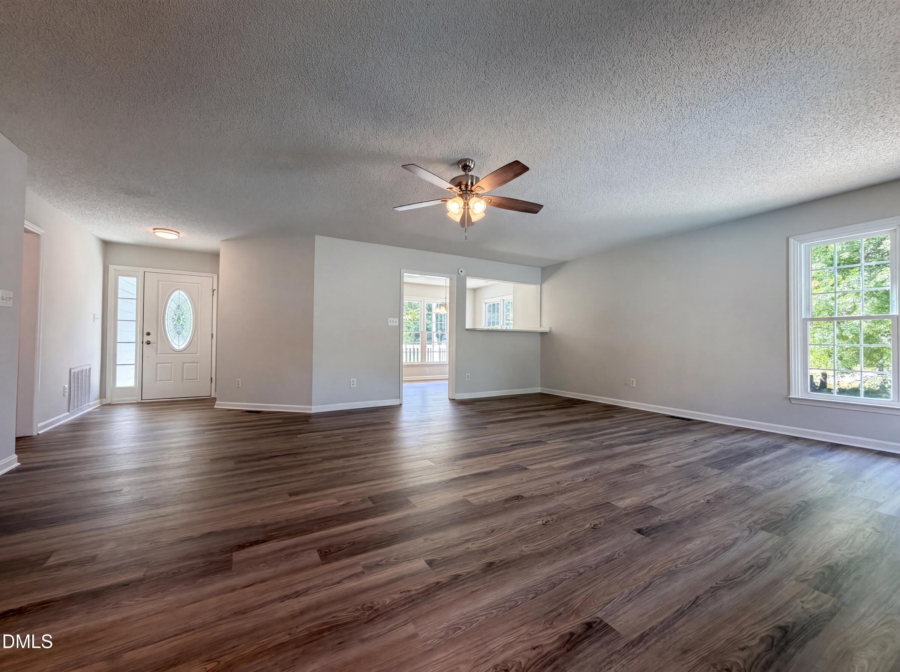 765 Trebor Drive Garner, NC 27529 - Photo 10 of 27 a view of an empty room with window and wooden floor