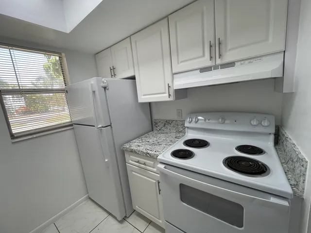 a kitchen with a stove and a refrigerator