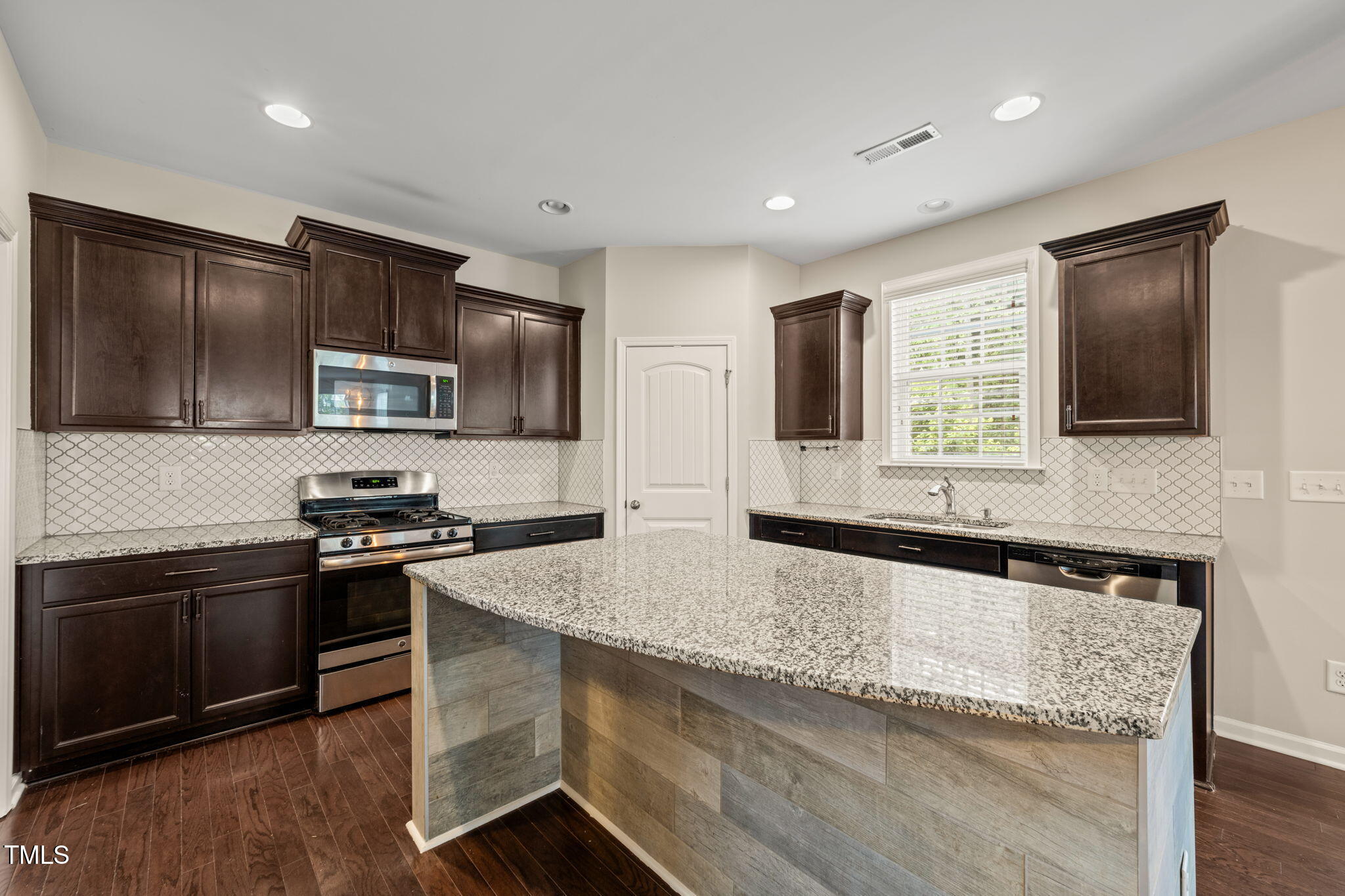 5011 Peachtree Town Lane Knightdale, NC 27545 - Photo 14 of 47 a kitchen with granite countertop stainless steel appliances and sink