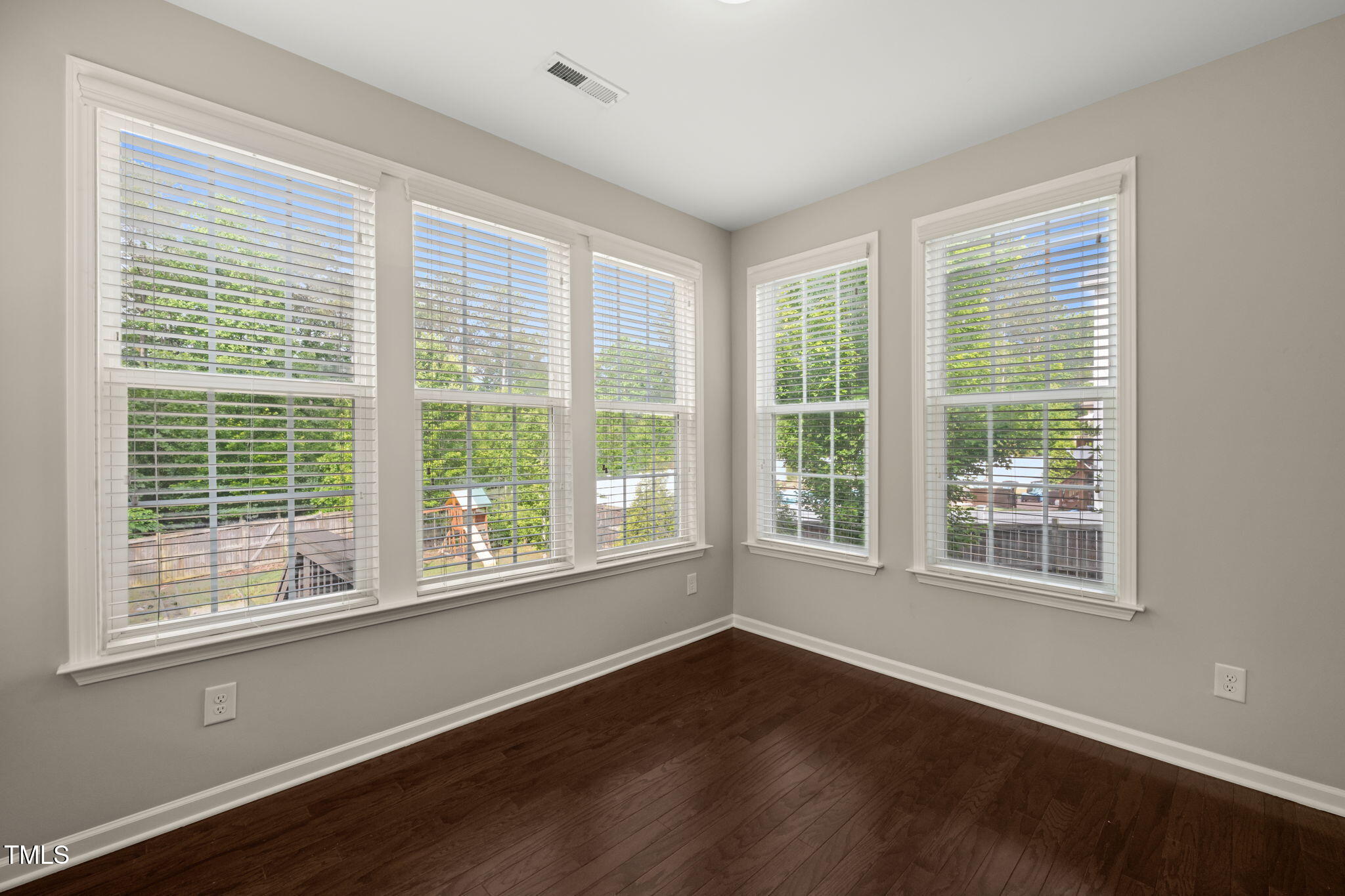5011 Peachtree Town Lane Knightdale, NC 27545 - Photo 19 of 47 a view of an empty room with wooden floor and a window