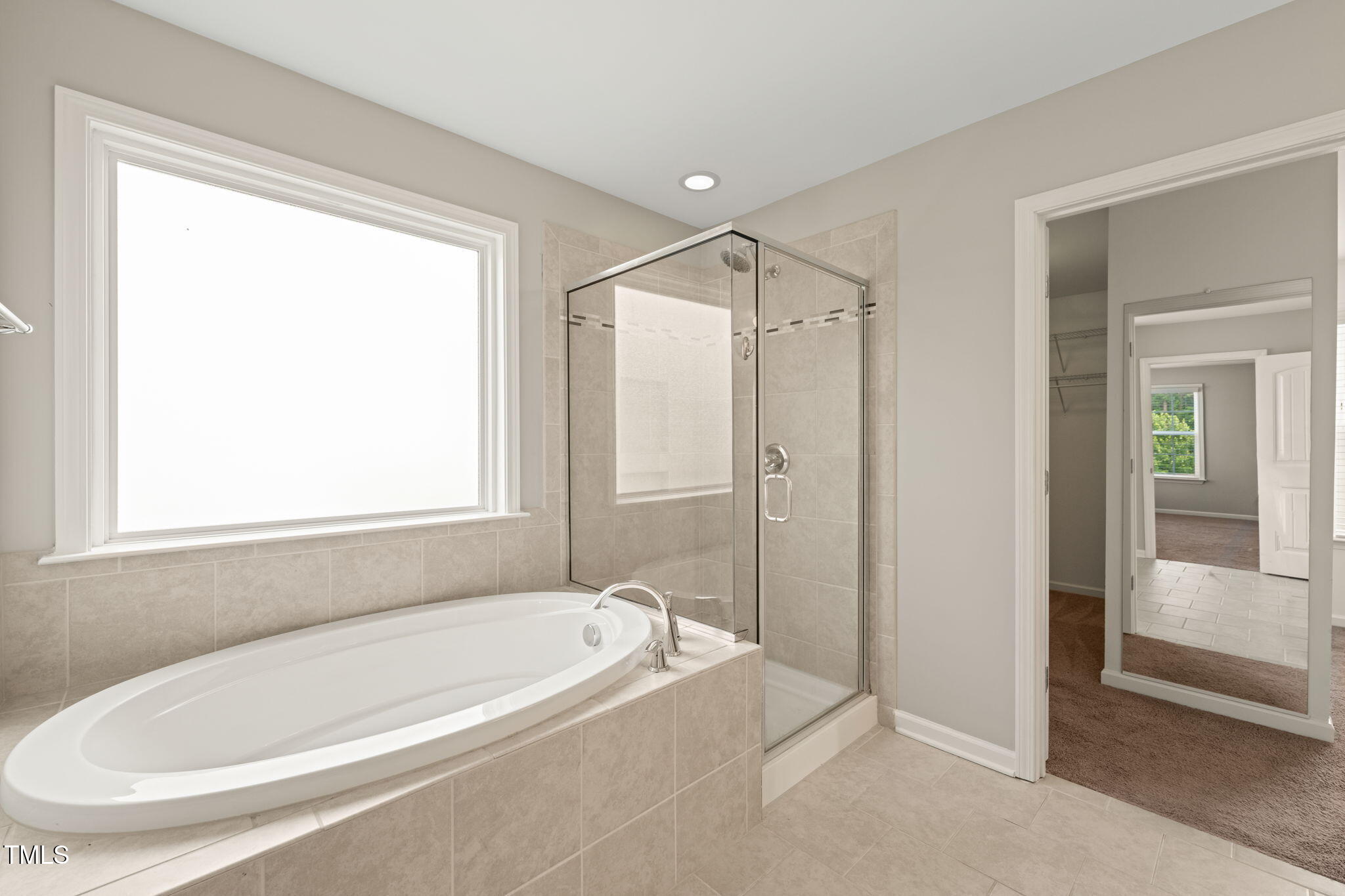 5011 Peachtree Town Lane Knightdale, NC 27545 - Photo 29 of 47 a bathroom with a tub and a shower