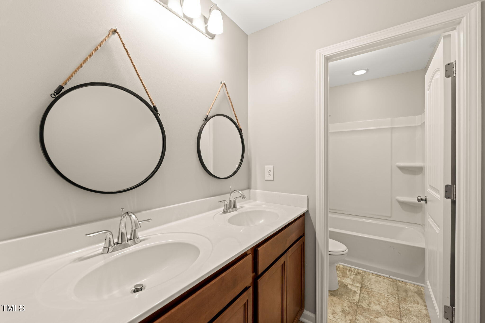 5011 Peachtree Town Lane Knightdale, NC 27545 - Photo 37 of 47 a bathroom with a sink and a mirror