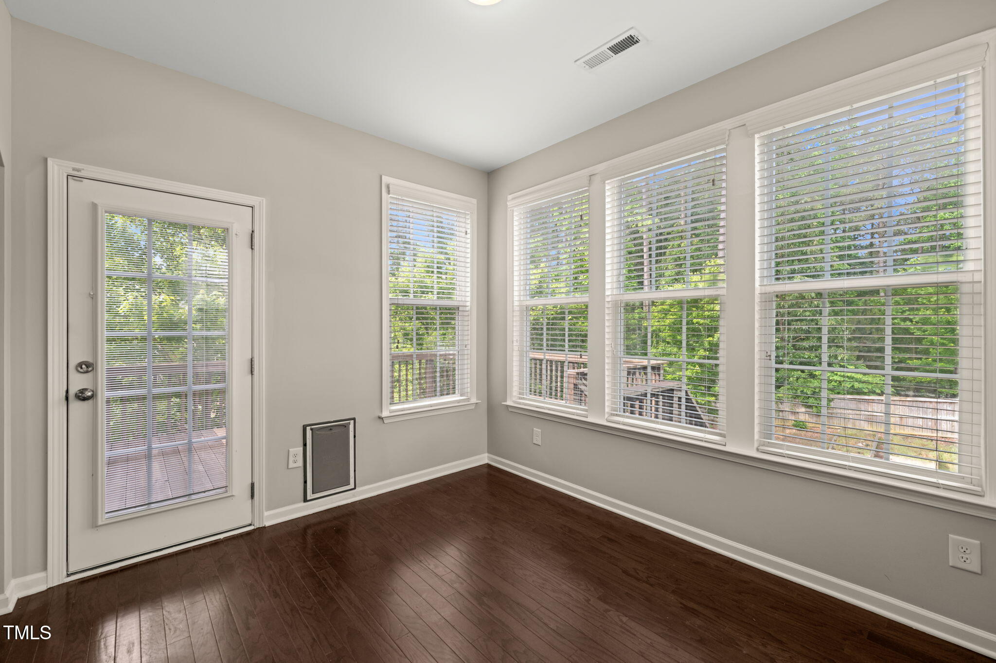5011 Peachtree Town Lane Knightdale, NC 27545 - Photo 5 of 47 a view of an empty room with wooden floor and a window
