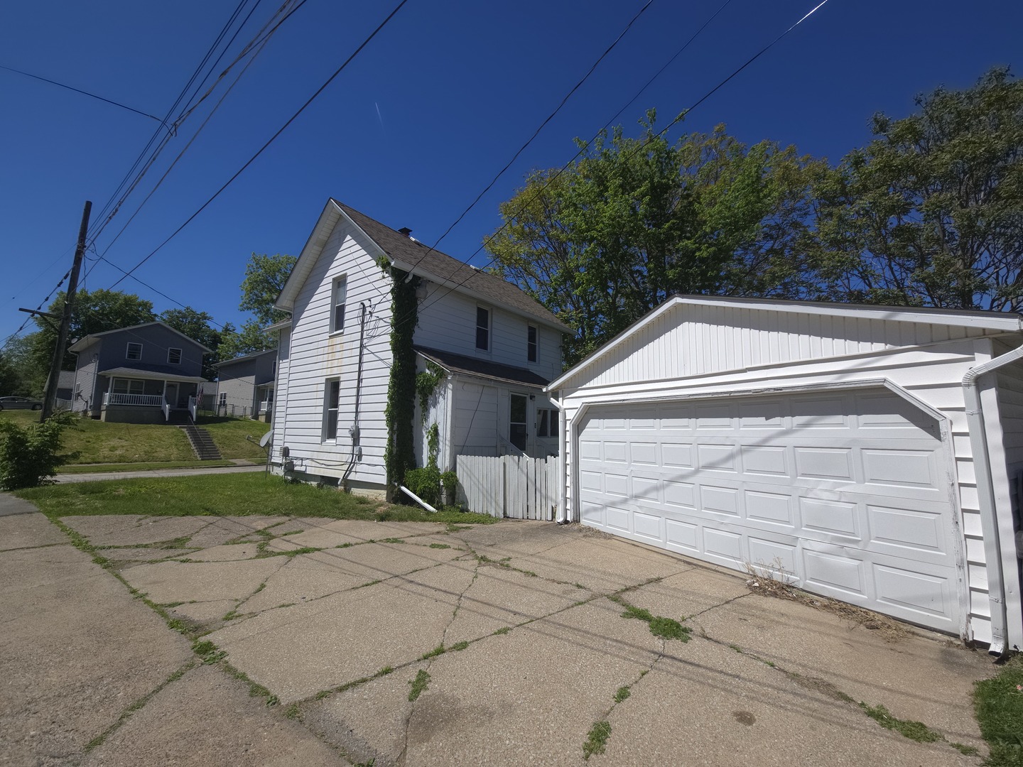1306 17th Street Moline, IL 61265 - Photo 3 of 14 a front view of a house with a yard and garage