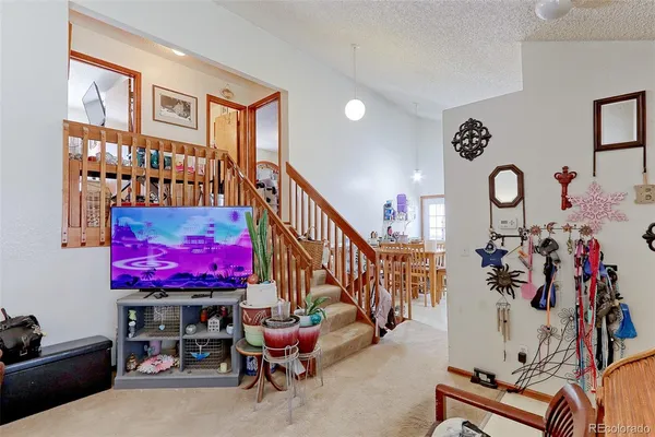 a living room with furniture and a floor to ceiling window