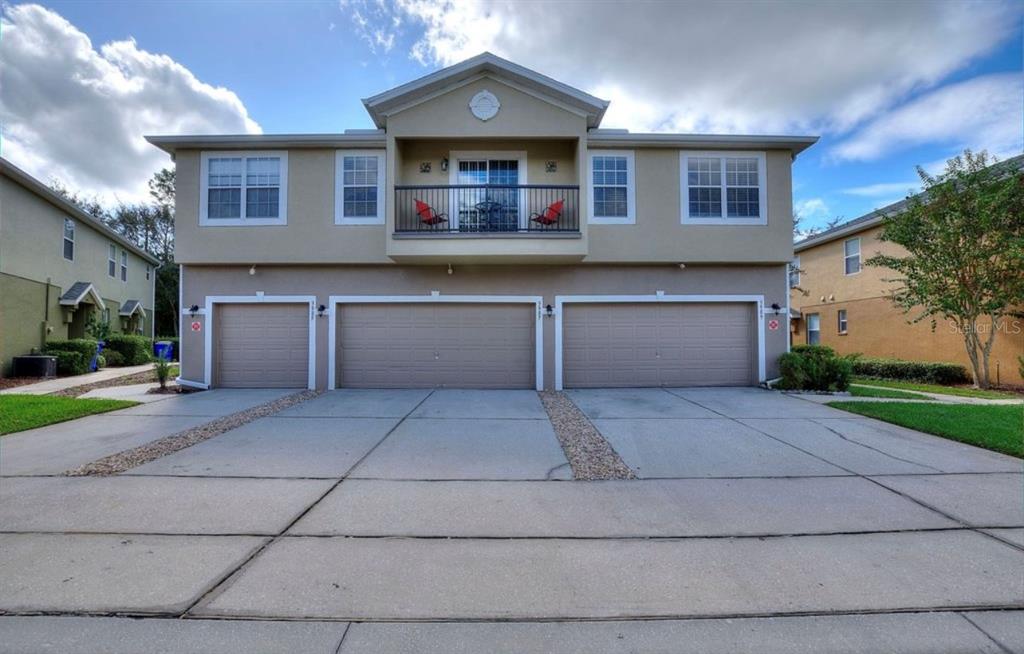 3989 Pemberly Pines Circle St. Cloud, FL 34769 - Photo 1 of 1 a front view of a house with a yard and a garage