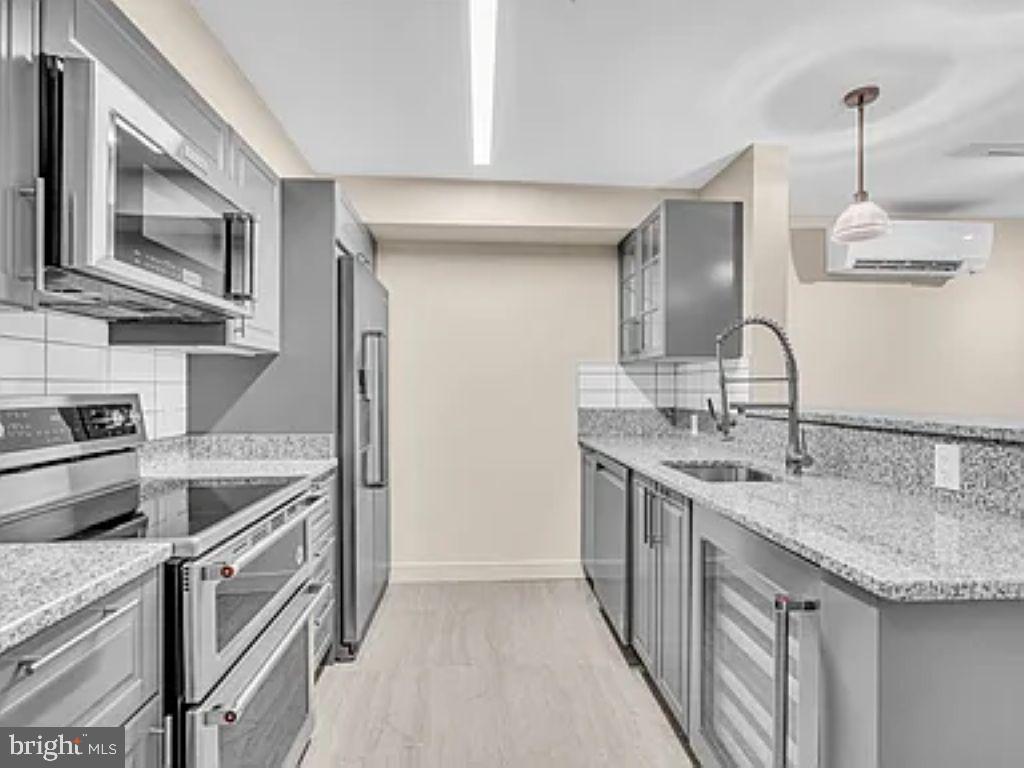 a kitchen with stainless steel appliances granite countertop a sink and stove top oven