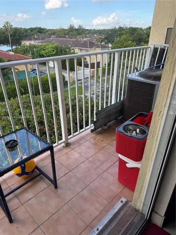 a view of a two chairs in the balcony