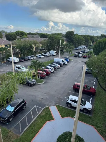 a view of a patio with chairs and plants