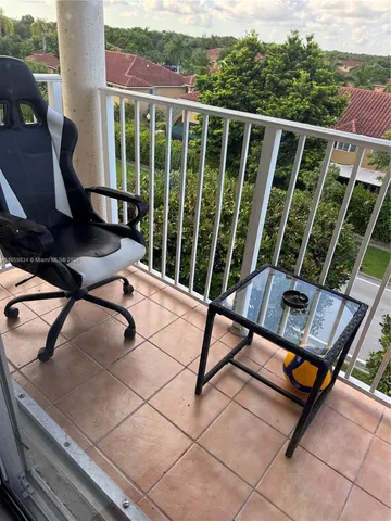 a view of a chairs and table in the roof deck