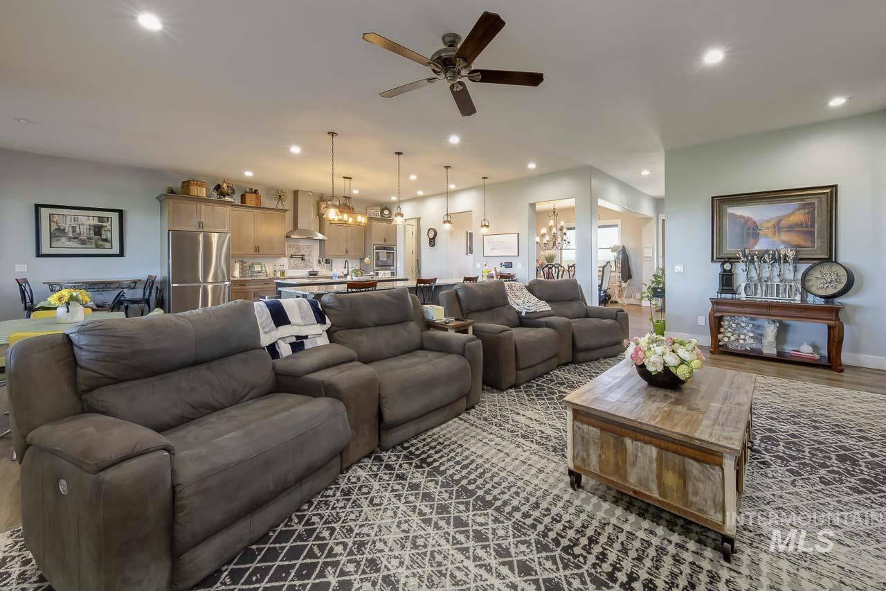 415 North Locust Grove Road Kuna, ID 83634 - Photo 20 of 49 Living room featuring recessed lighting, a chandelier, wood finished floors, and ceiling fan