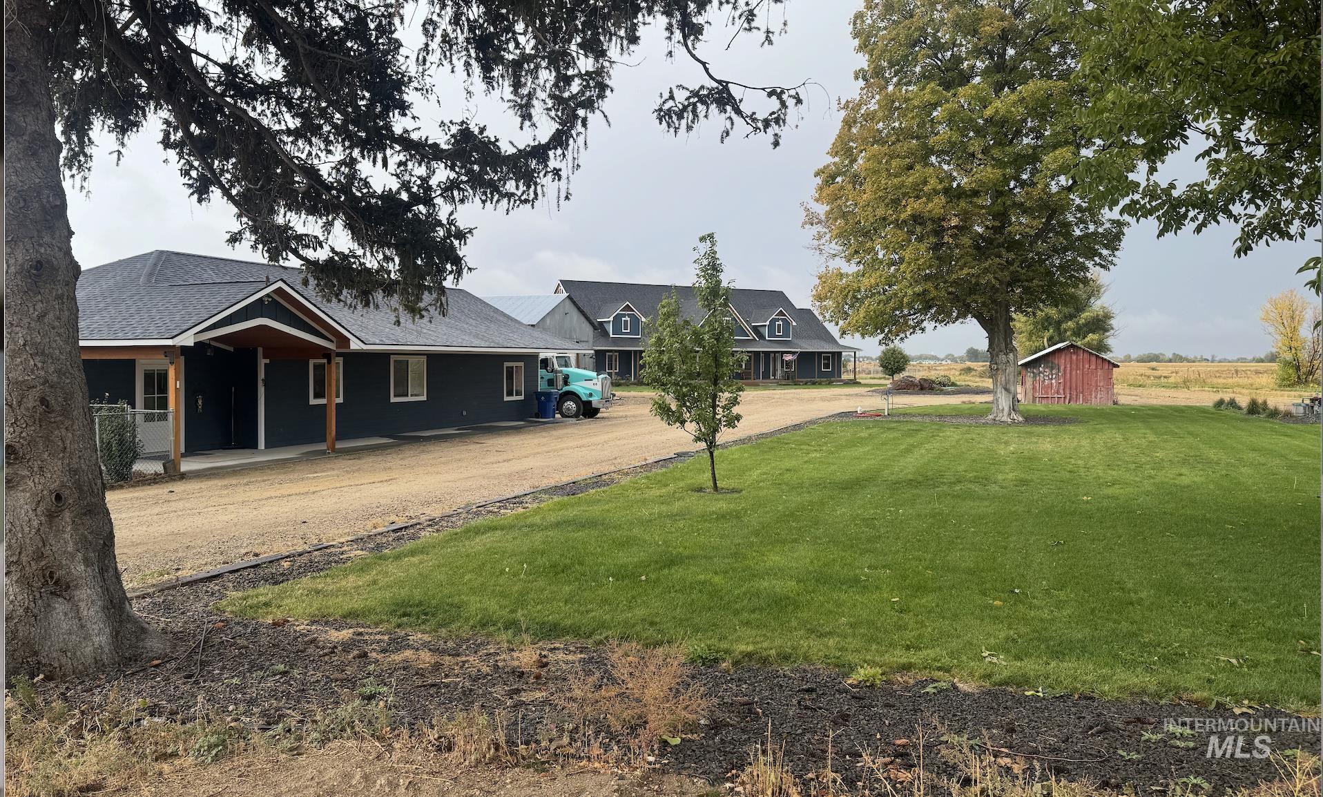 415 North Locust Grove Road Kuna, ID 83634 - Photo 3 of 49 View of green lawn featuring dirt driveway