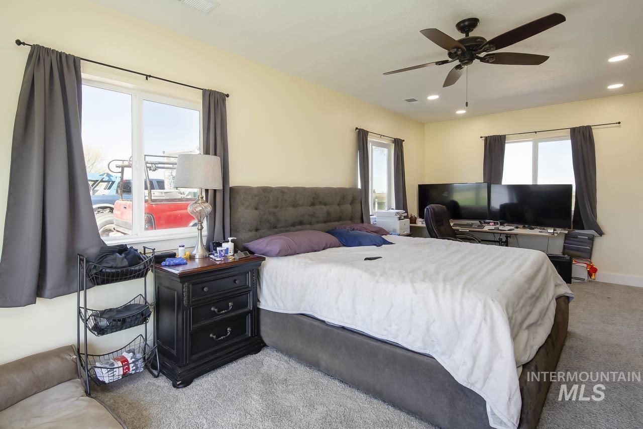 415 North Locust Grove Road Kuna, ID 83634 - Photo 39 of 49 Bedroom with light colored carpet, recessed lighting, and a ceiling fan