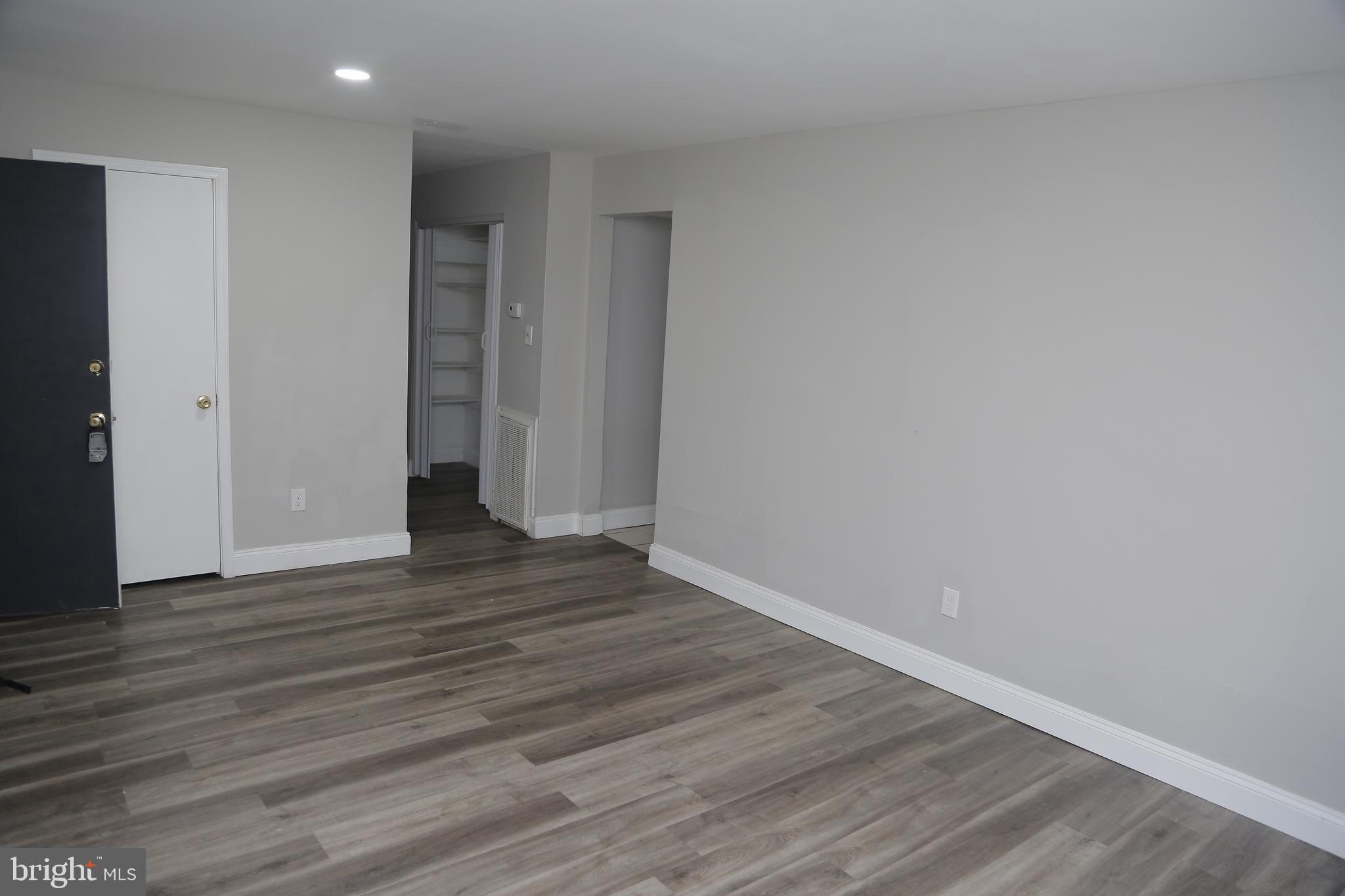 4209 Ridgewood Avenue, Unit 4 Baltimore, MD 21215 - Photo 3 of 17 a view of an empty room with wooden floor and closet