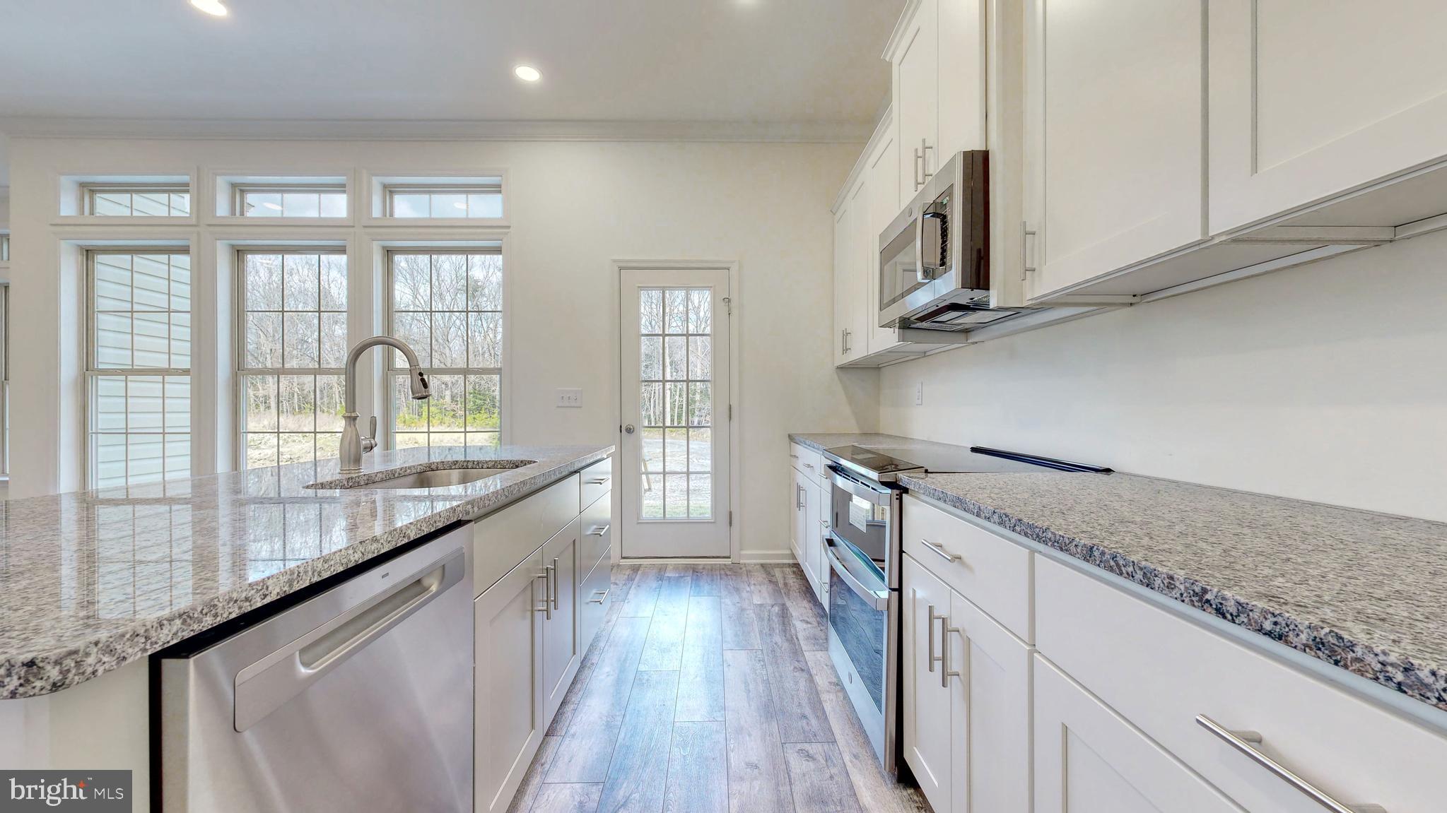 1 Wilson Hill Road Georgetown, DE 19947 - Photo 11 of 36 a kitchen with stainless steel appliances granite countertop a stove and a sink