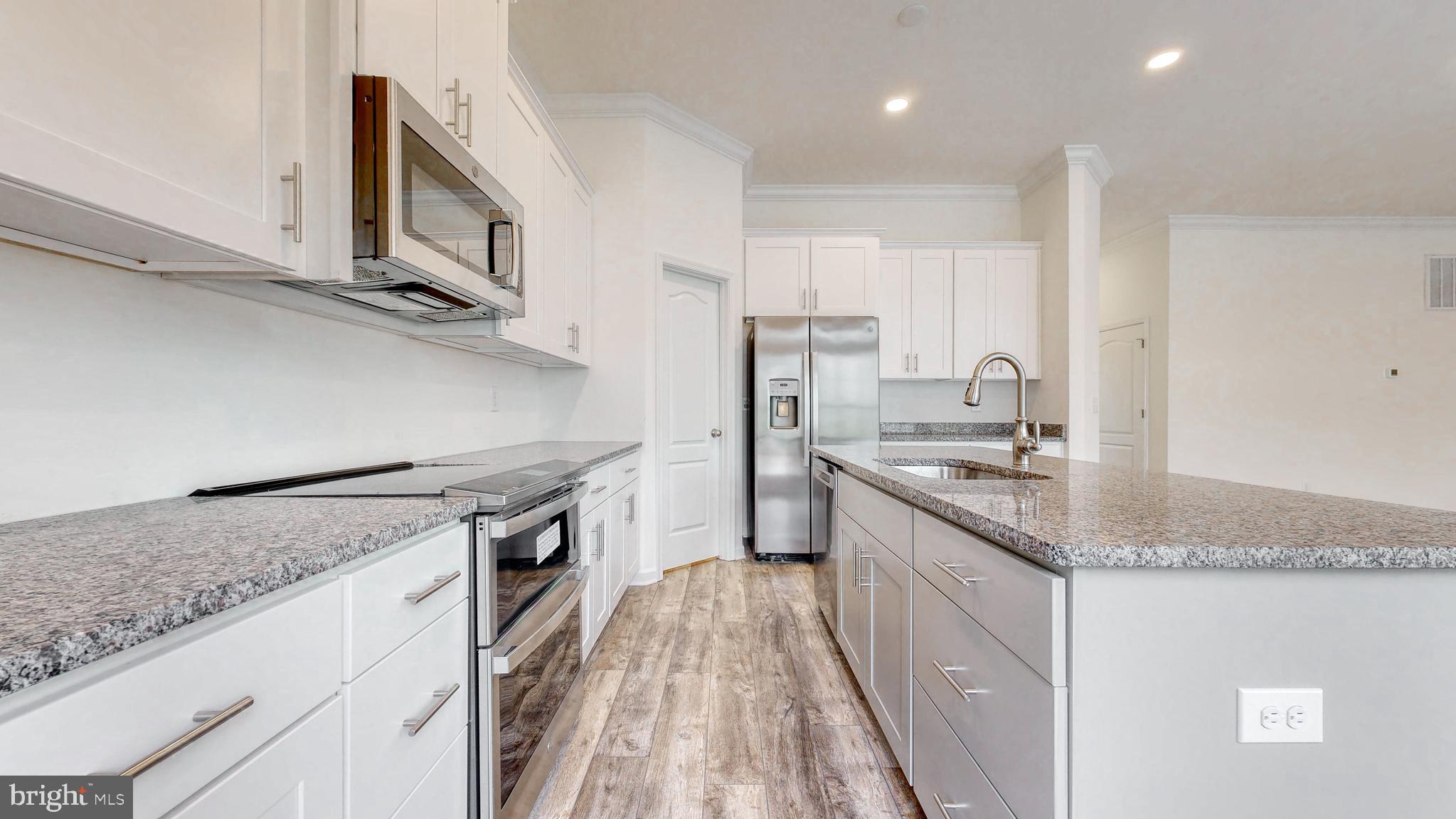 1 Wilson Hill Road Georgetown, DE 19947 - Photo 12 of 36 a kitchen with stainless steel appliances granite countertop a sink stove and refrigerator
