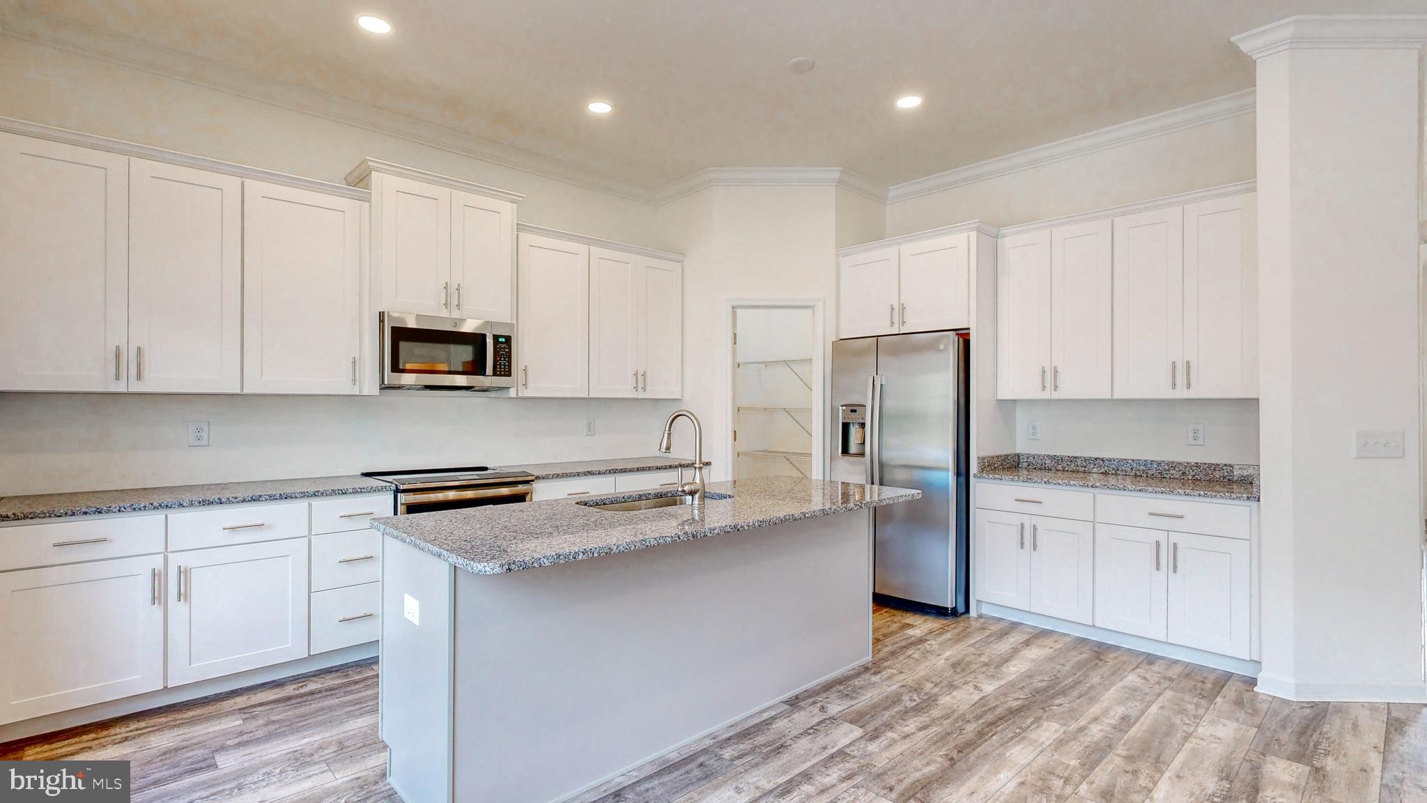 1 Wilson Hill Road Georgetown, DE 19947 - Photo 6 of 36 a kitchen with white cabinets and stainless steel appliances