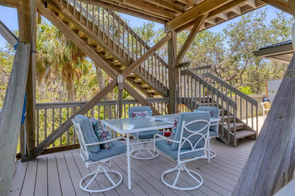 7475 Manasota Key Road Englewood, FL 34223 - Photo 66 of 79 a patio with wooden floor and outdoor seating