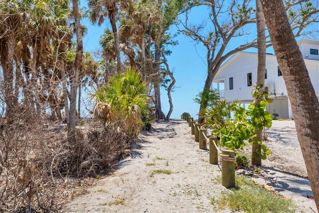 7475 Manasota Key Road Englewood, FL 34223 - Photo 9 of 79 a white vase with flowers sitting on a table