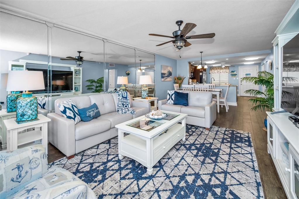14950 Gulf Boulevard, Unit 1206 Madeira Beach, FL 33708 - Photo 17 of 69 a living room with furniture and a chandelier