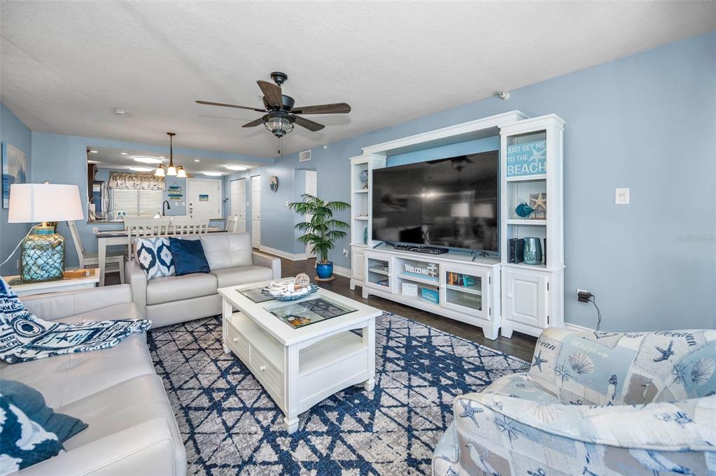 14950 Gulf Boulevard, Unit 1206 Madeira Beach, FL 33708 - Photo 18 of 69 a living room with furniture and a flat screen tv