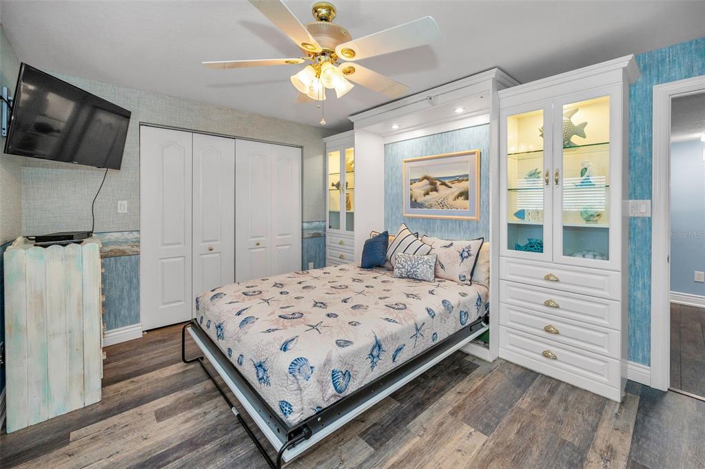 14950 Gulf Boulevard, Unit 1206 Madeira Beach, FL 33708 - Photo 25 of 69 a bedroom with a bed and a flat screen tv