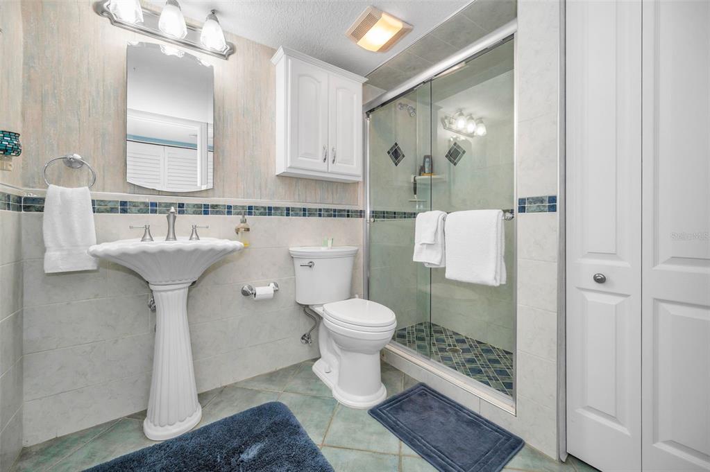 14950 Gulf Boulevard, Unit 1206 Madeira Beach, FL 33708 - Photo 27 of 69 a bathroom with a sink toilet and shower