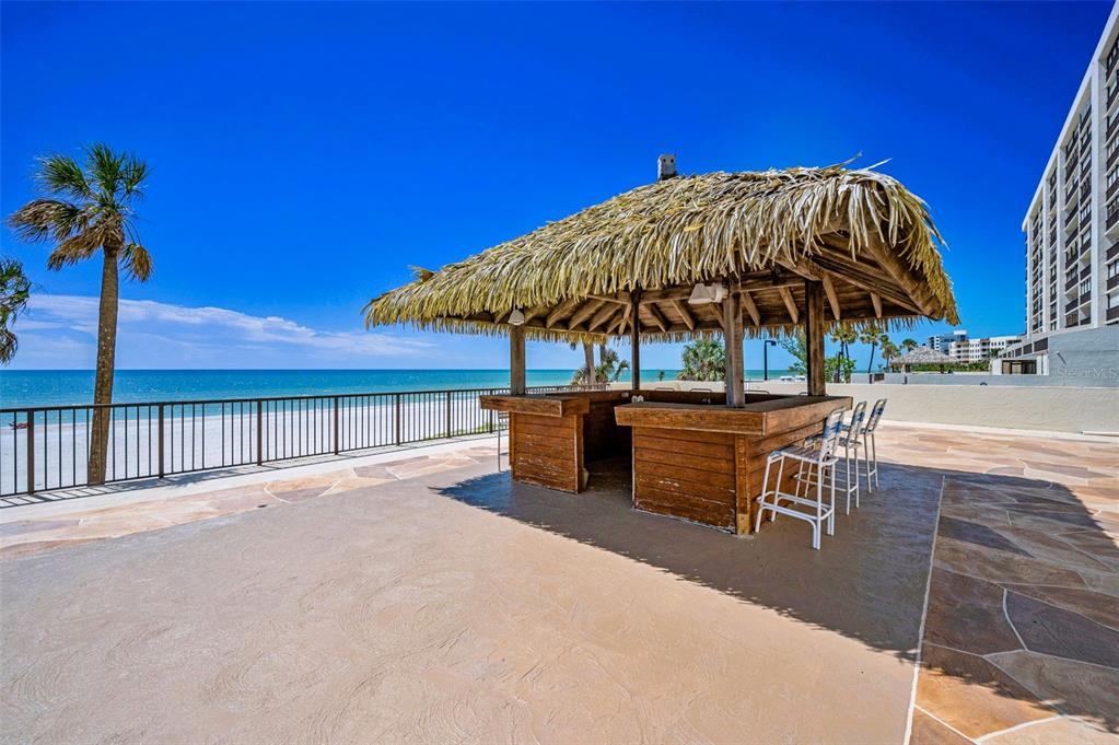 14950 Gulf Boulevard, Unit 1206 Madeira Beach, FL 33708 - Photo 45 of 69 a view of a tables and chairs under an umbrella in patio