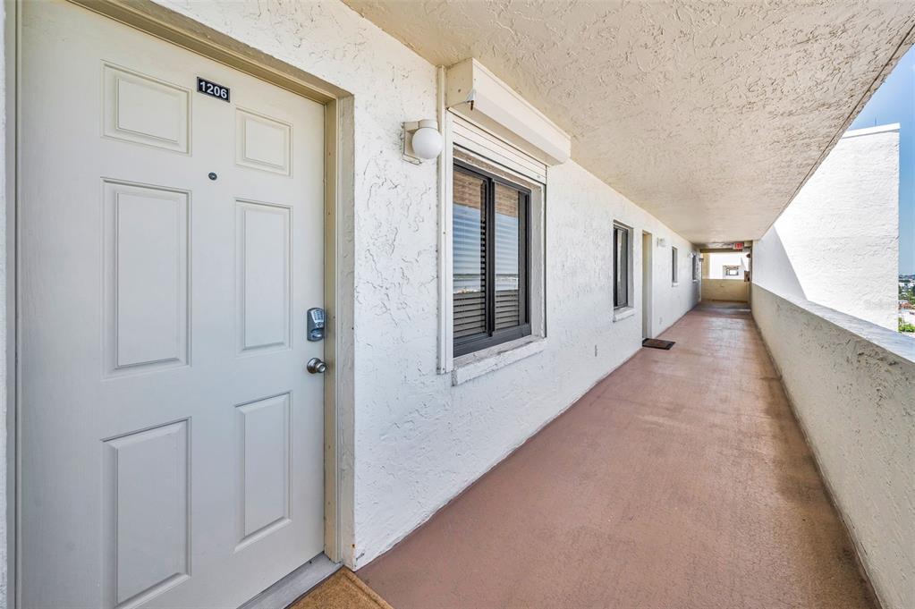14950 Gulf Boulevard, Unit 1206 Madeira Beach, FL 33708 - Photo 8 of 69 a view of a hallway with windows