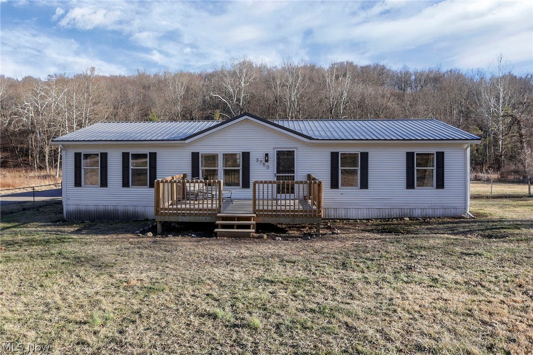 3750 Cannelville Road Roseville, OH 43777 - Photo 1 of 33 Manufactured / mobile home featuring a metal roof and a wooden deck