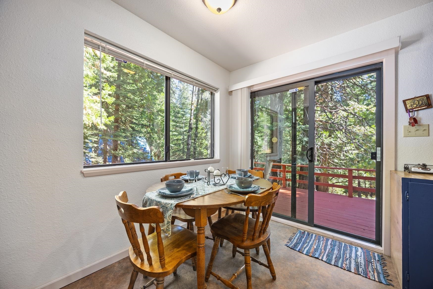 41080 Putt Road Emigrant Gap, CA 95715 - Photo 8 of 21 a dining room with furniture large windows and wooden floor