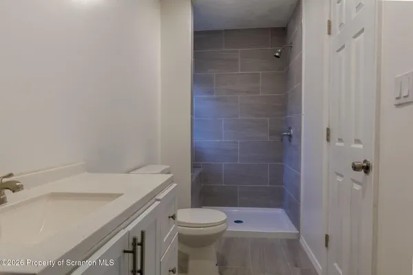a bathroom with a toilet and a shower