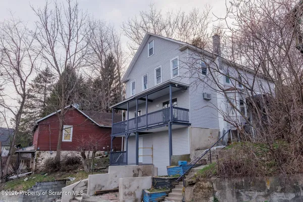 a pathway of a house with a yard