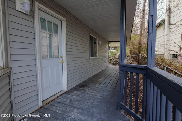 a view of a balcony with wooden floor