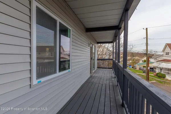 a view of entryway with wooden floor and stairs