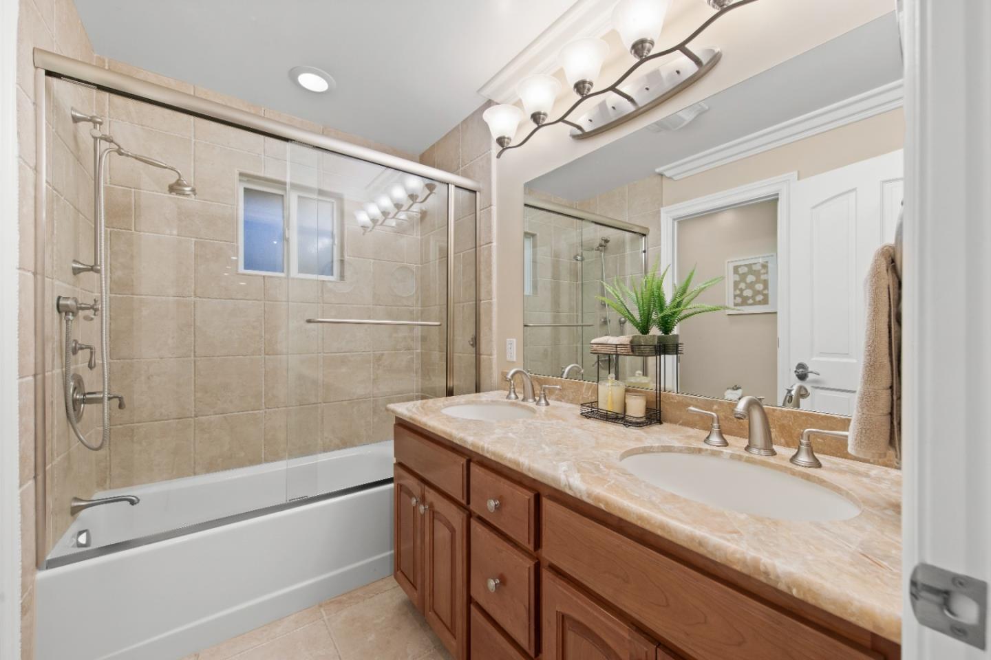10495 Scenic Boulevard Cupertino, CA 95014 - Photo 19 of 30 a bathroom with a granite countertop sink a mirror a bathtub and shower
