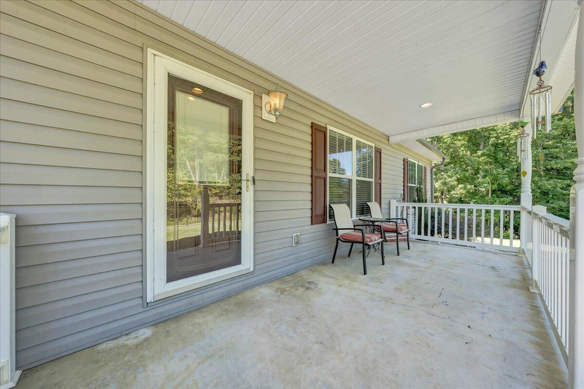 485 Foothills Road Callaway, VA 24067 - Photo 5 of 39 a view of a porch with furniture and a yard